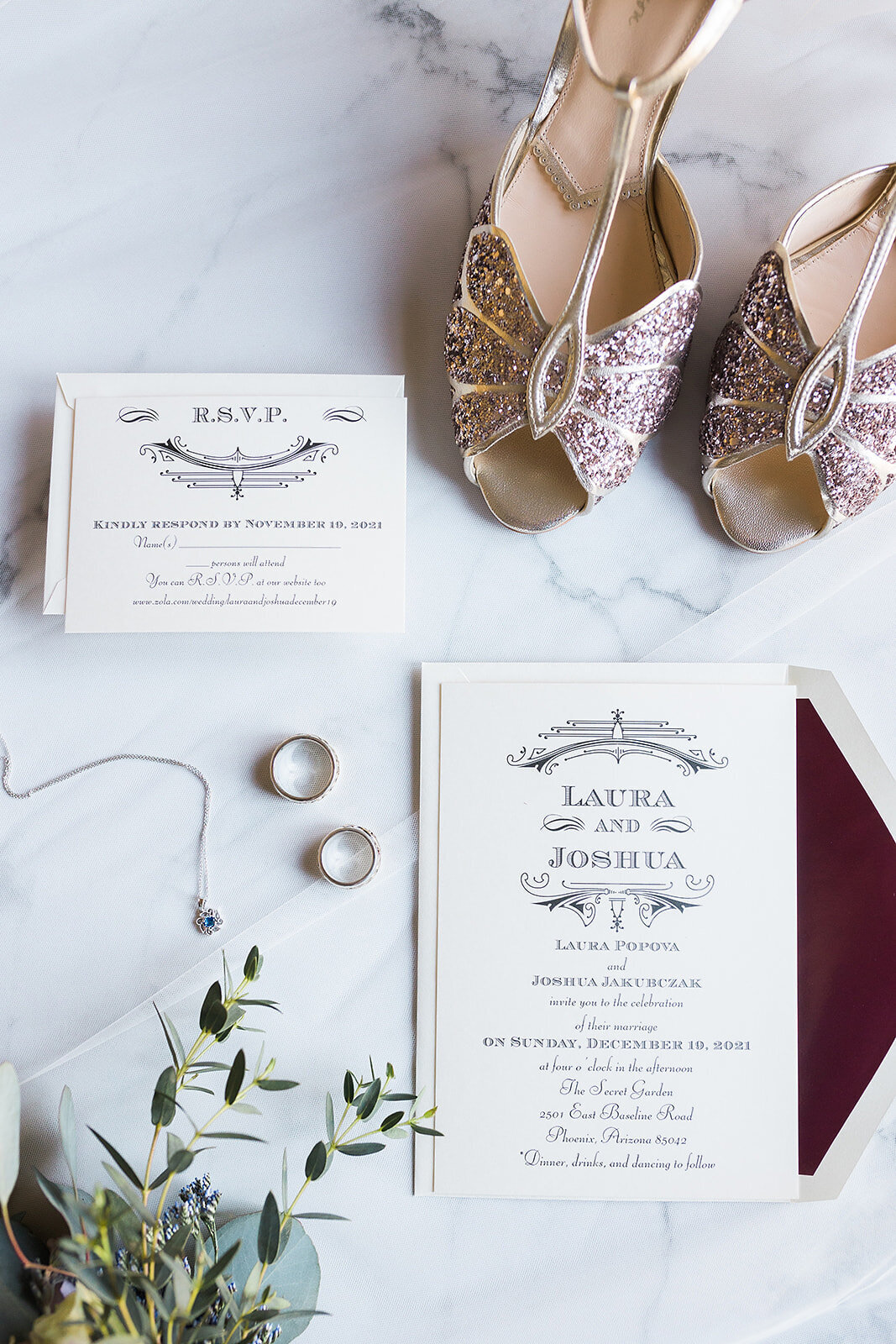 Flat lay of rings, invitations, and sparkly pink shoes