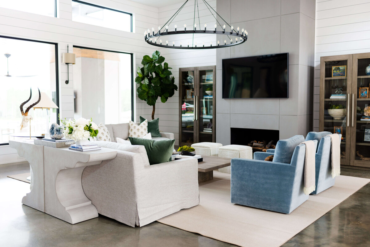 oyster creek studios building belt new build blue sofa and blue chairs in living room