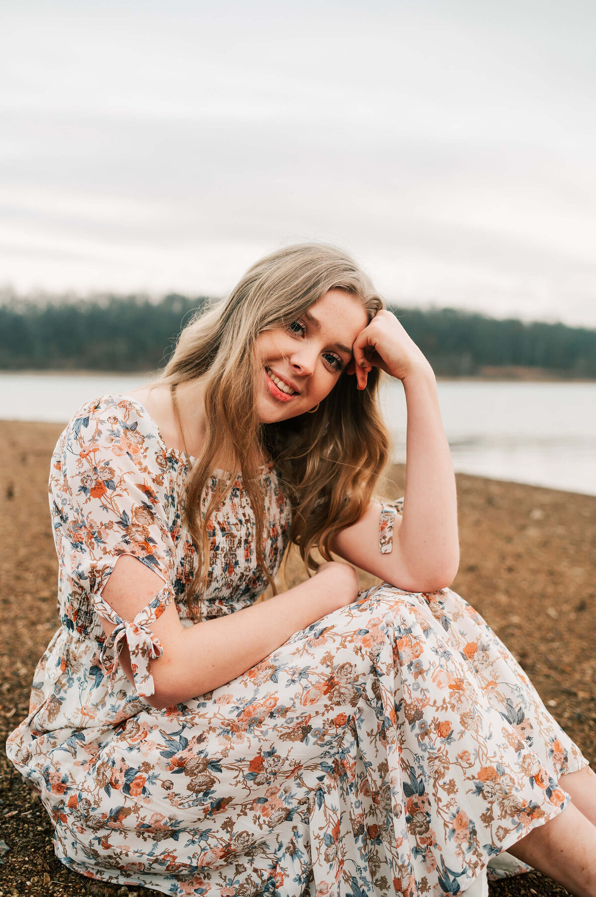 senior pictures in Springfield MO of high school senior sitting in the sand during Branson Missouri senior photography session