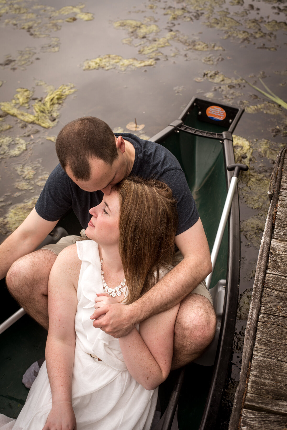 Couple kisses in canoe at Portage Lakes park