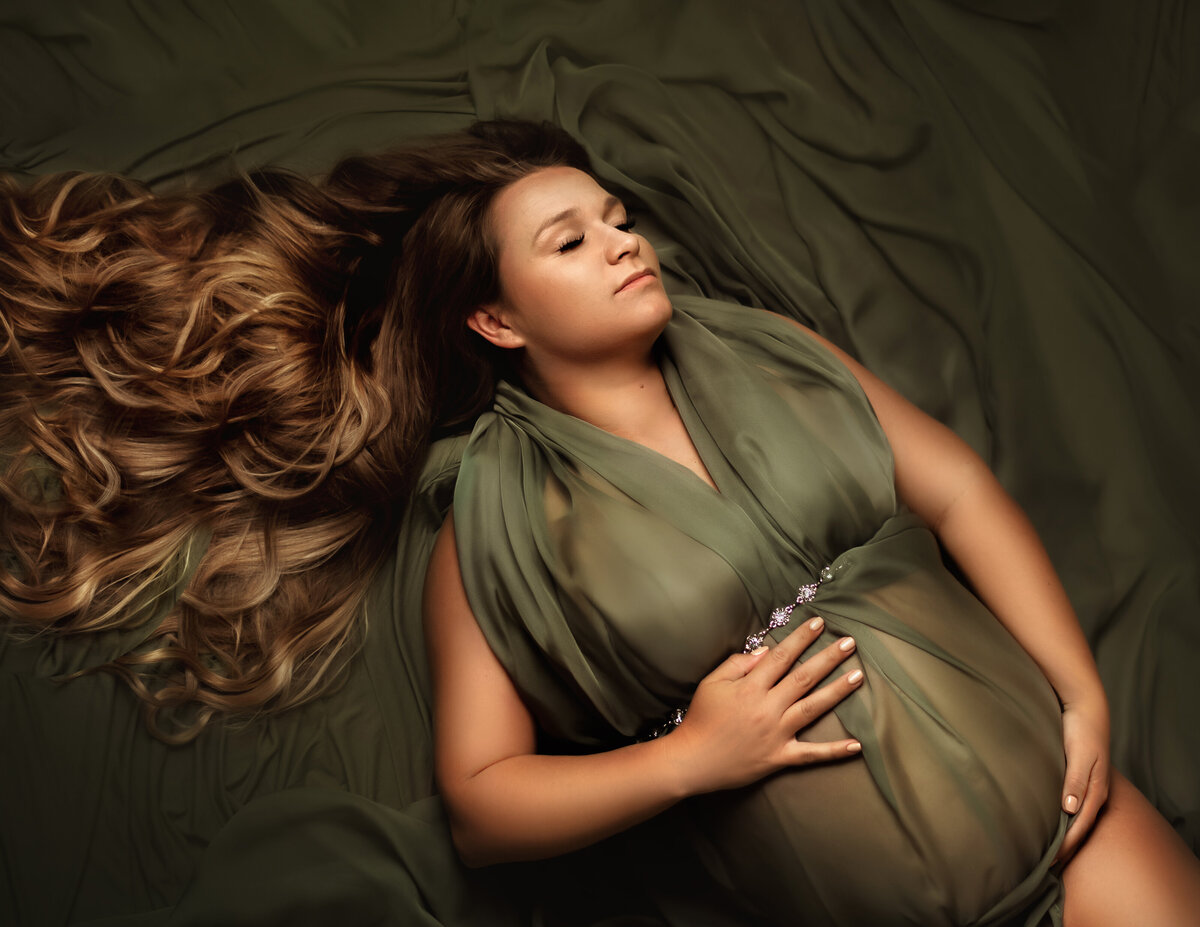 Mom laying down with maternity photo