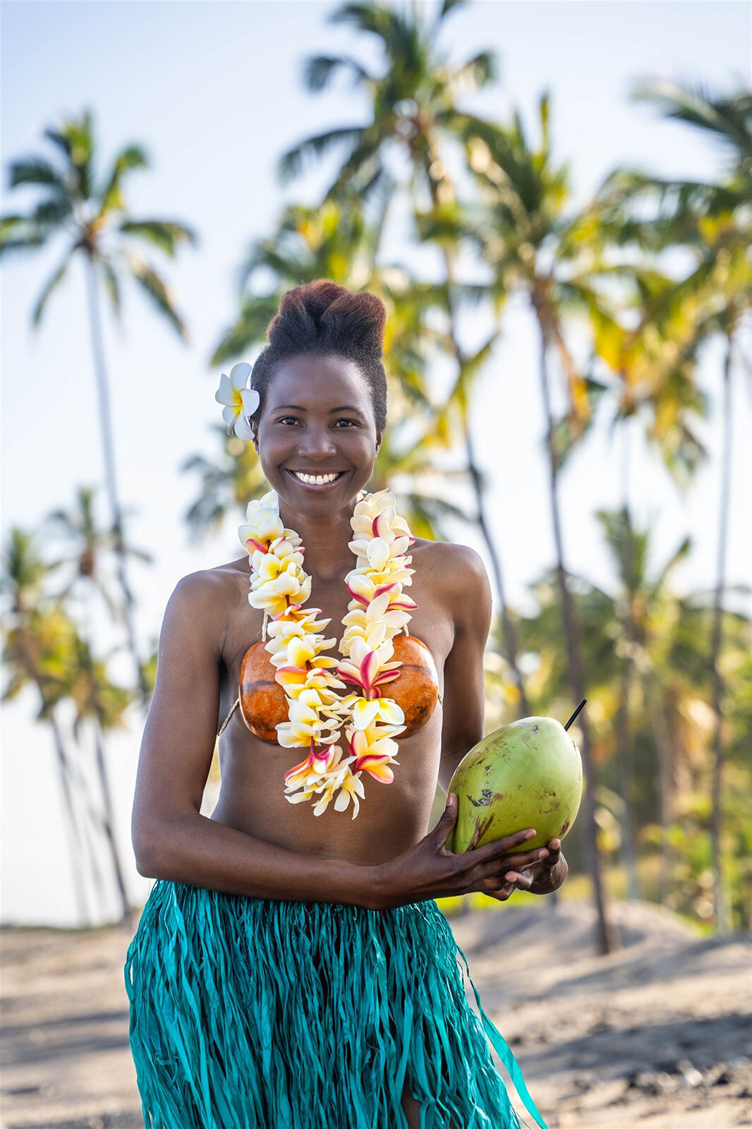 Woman wearing lei and coconuts for hawaii senior portraits