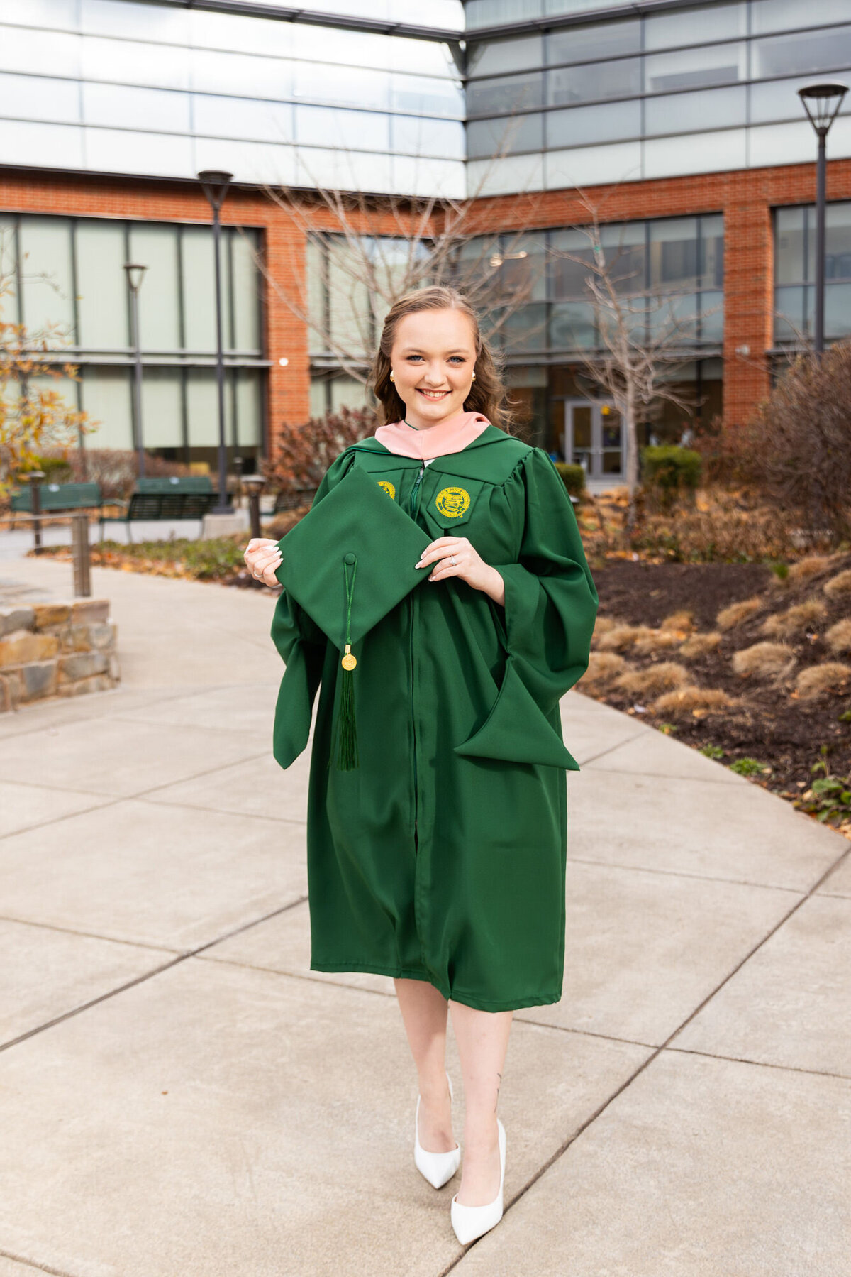 Girl holding cap while in gown at George Mason University