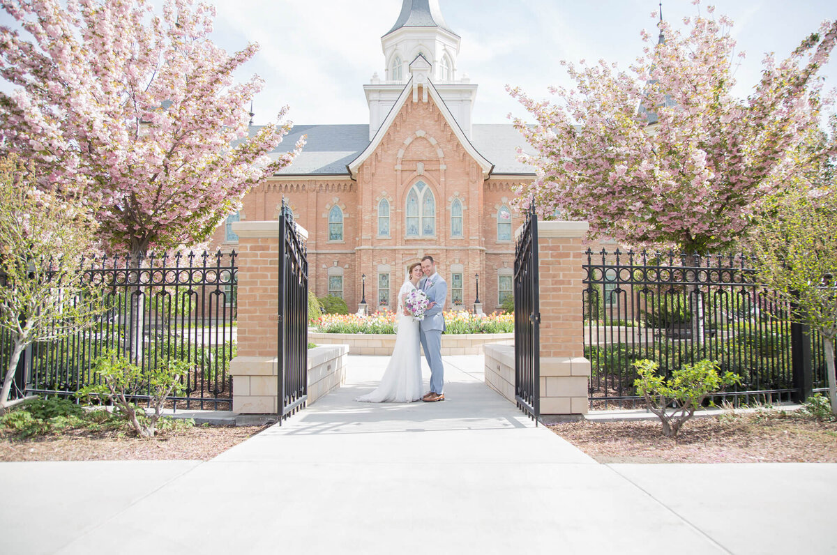 portrait of a wedding couple in front of lds temple