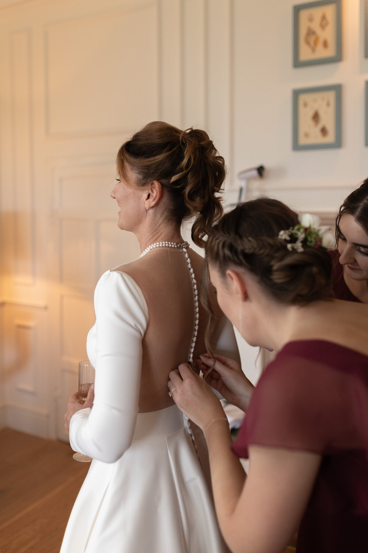 The bride gets into her Justin Alexander wedding dress