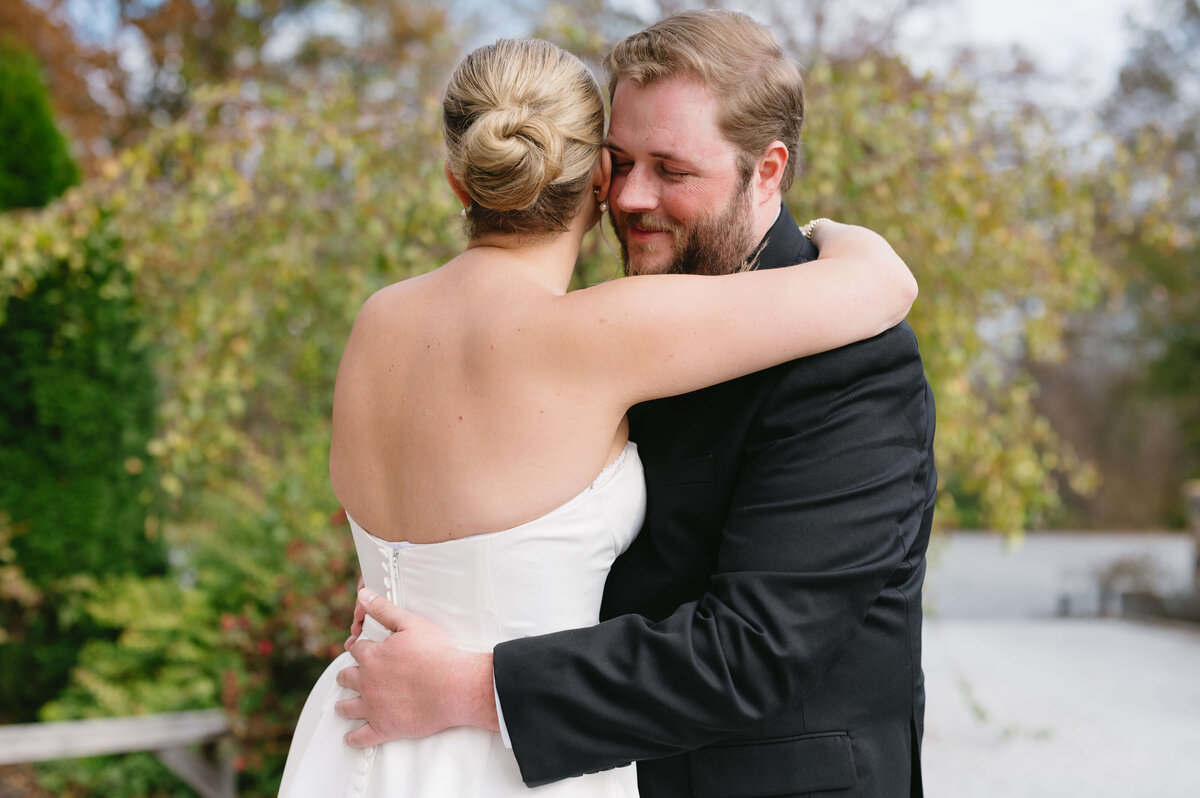 bride and groom hugging each other after a first look in a garden of their outdoor wedding venue in Charlottesville VA