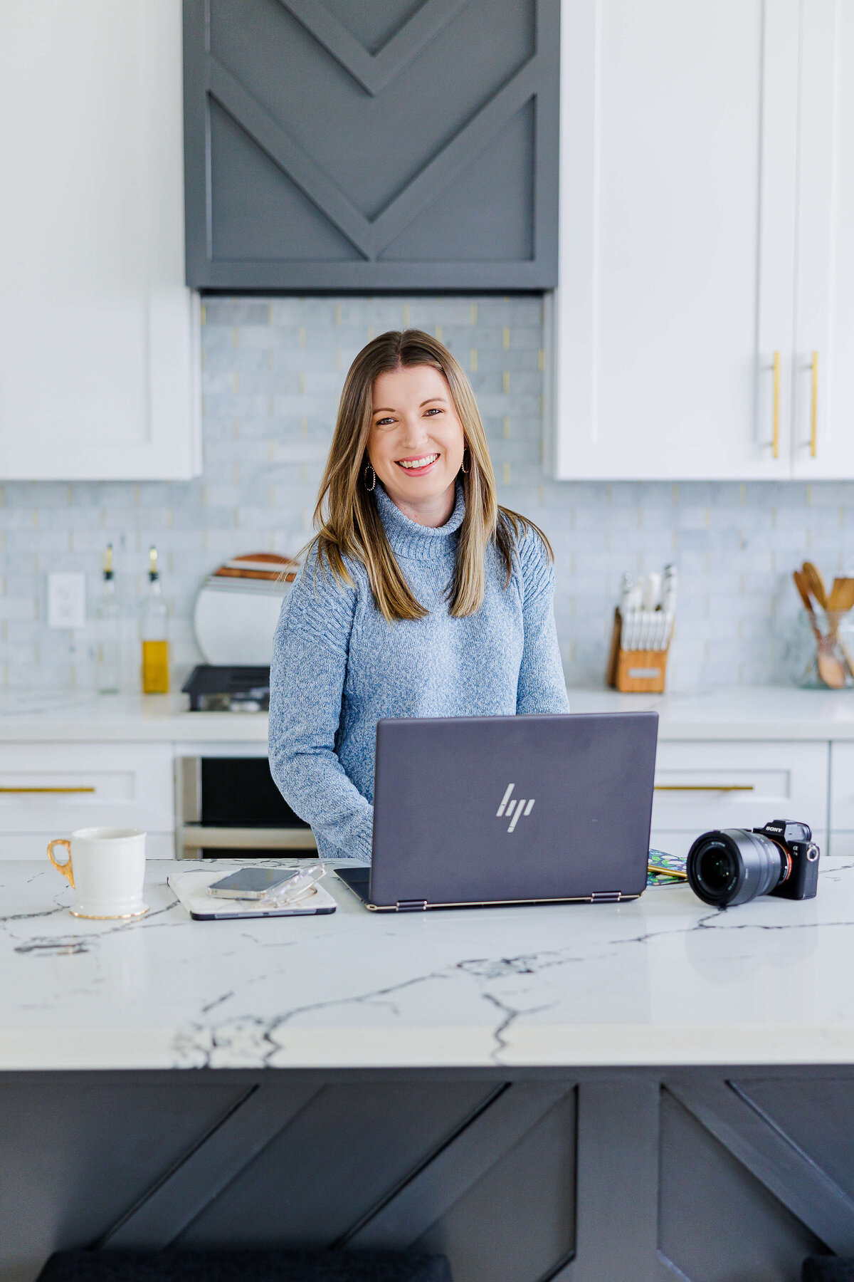 Lady working on laptop in kitchen