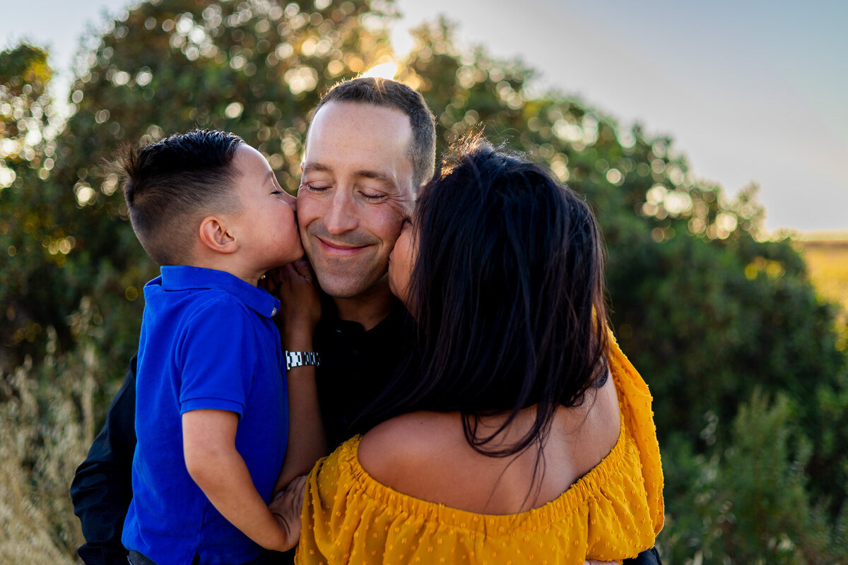 Sweet moment as mom and son each kiss dad’s cheeks at sunset – Bay Area Family Portfolio - Ellobelle Photography