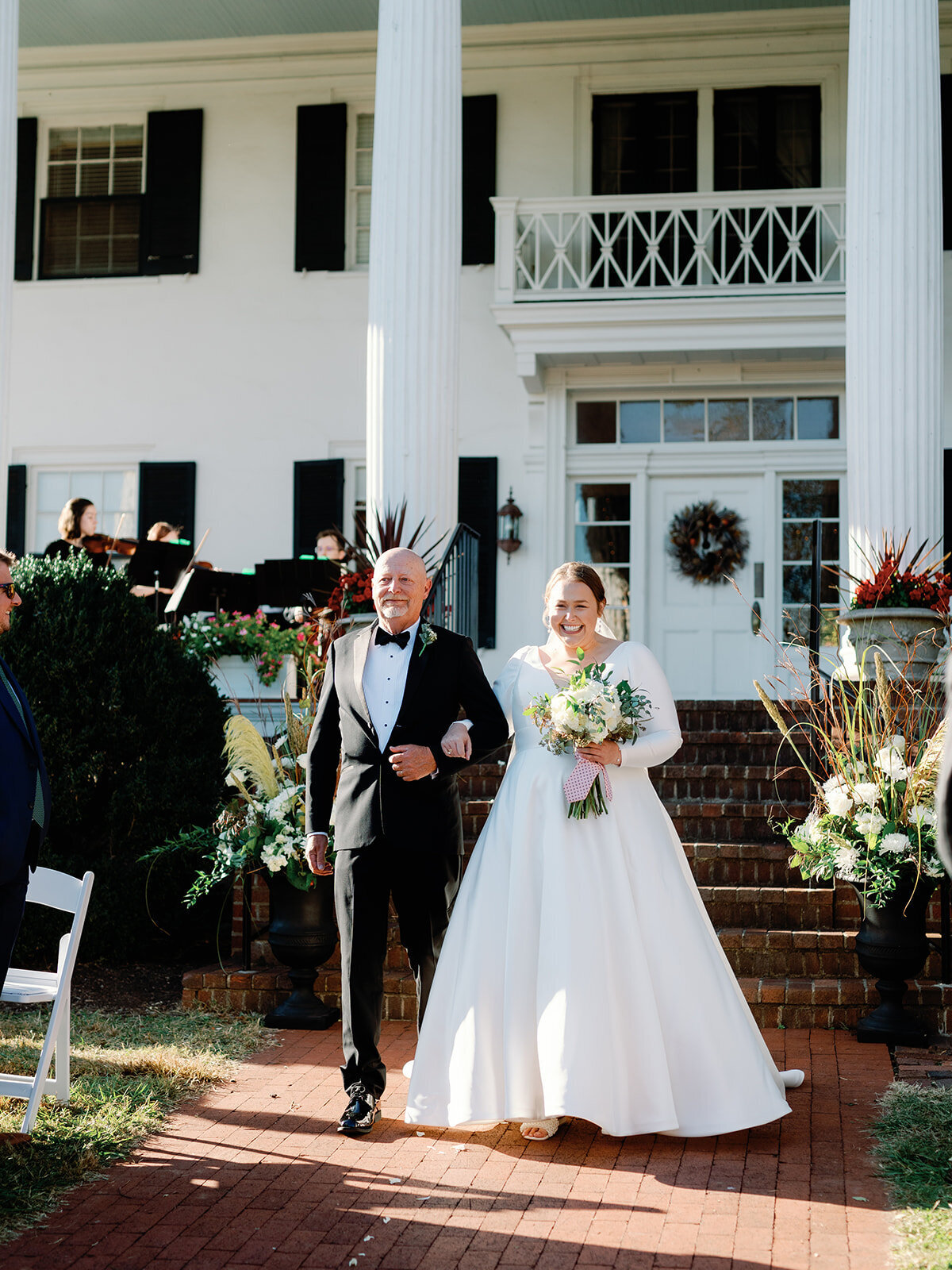 Bride and her dad walk down the aisle at rosemont manor
