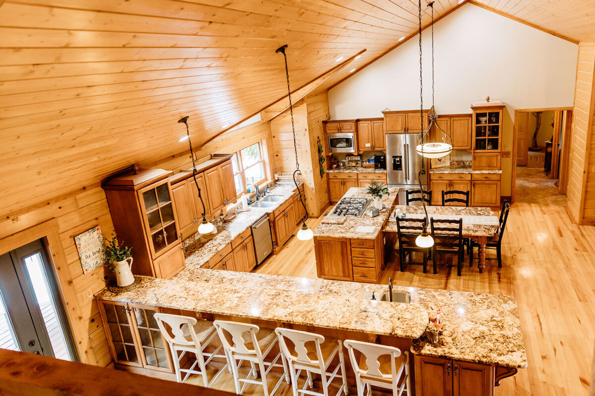 Spacious kitchen with wooden cabinets and marble countertops