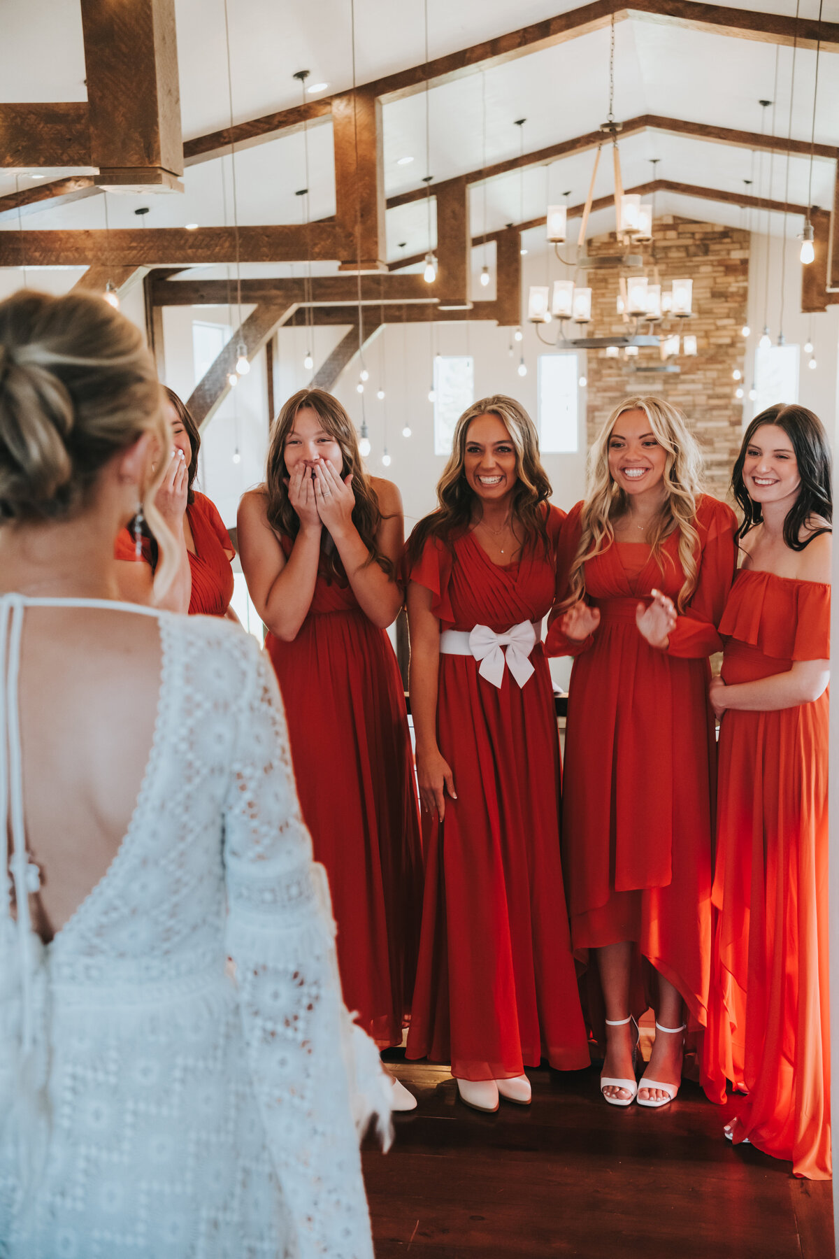 Bridesmaids reacting as they see the bride