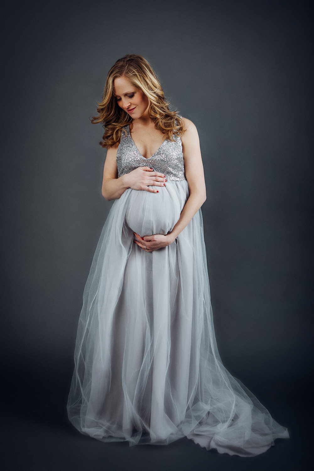 Beauty portrait of pregnant woman in a pastel blue maxi dress