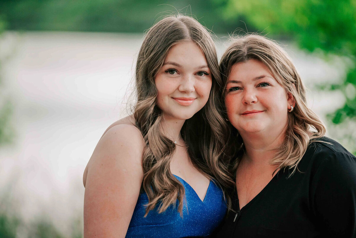 The graduate and her mom in a close up portrait. 