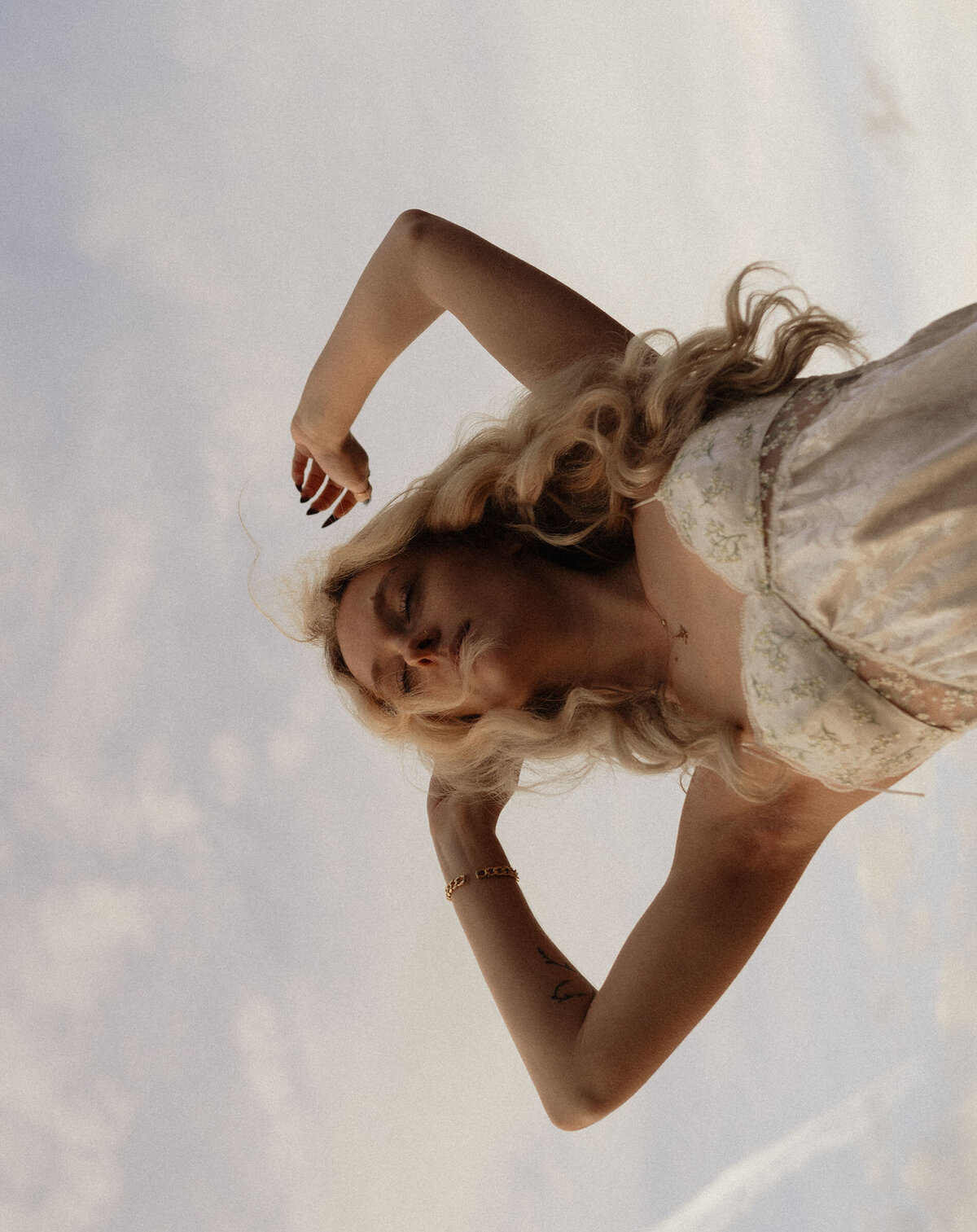 artistic photo of a woman posing against the cloudy sky in Bend, Oregon