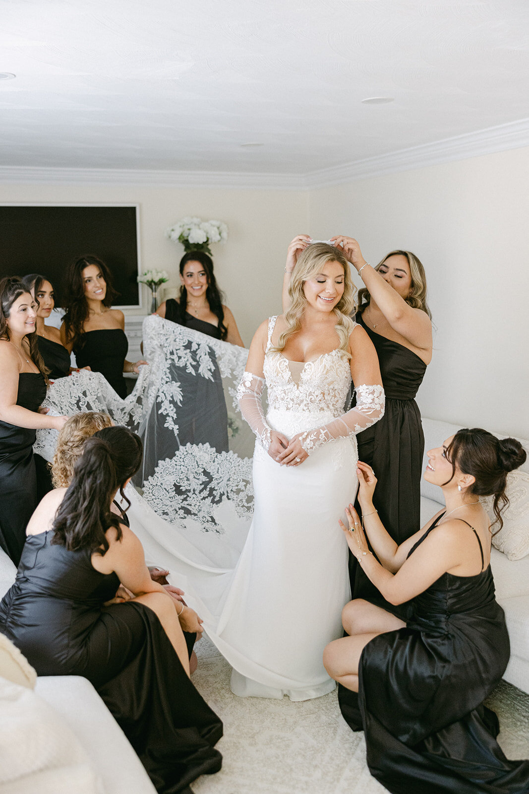 bridesmaids helping a bride get ready on her wedding day