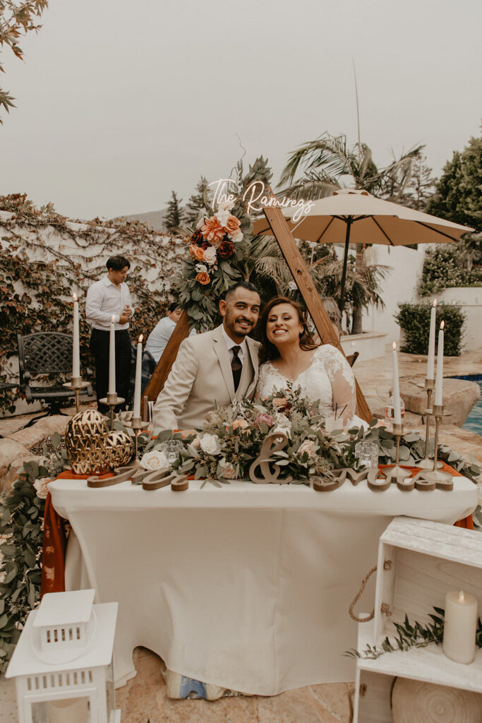 Sweetheart table with gold details and neon sign
