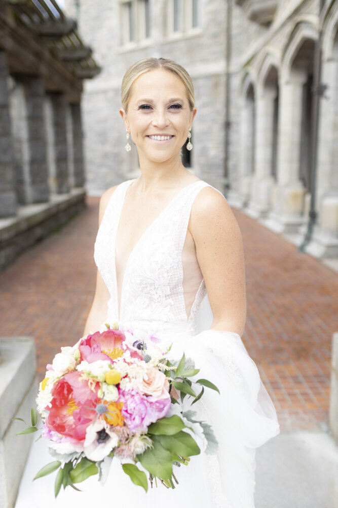 bride smiling on wedding day with gorgeous pink bouquet - gold shoes and wedding details - branford house wedding