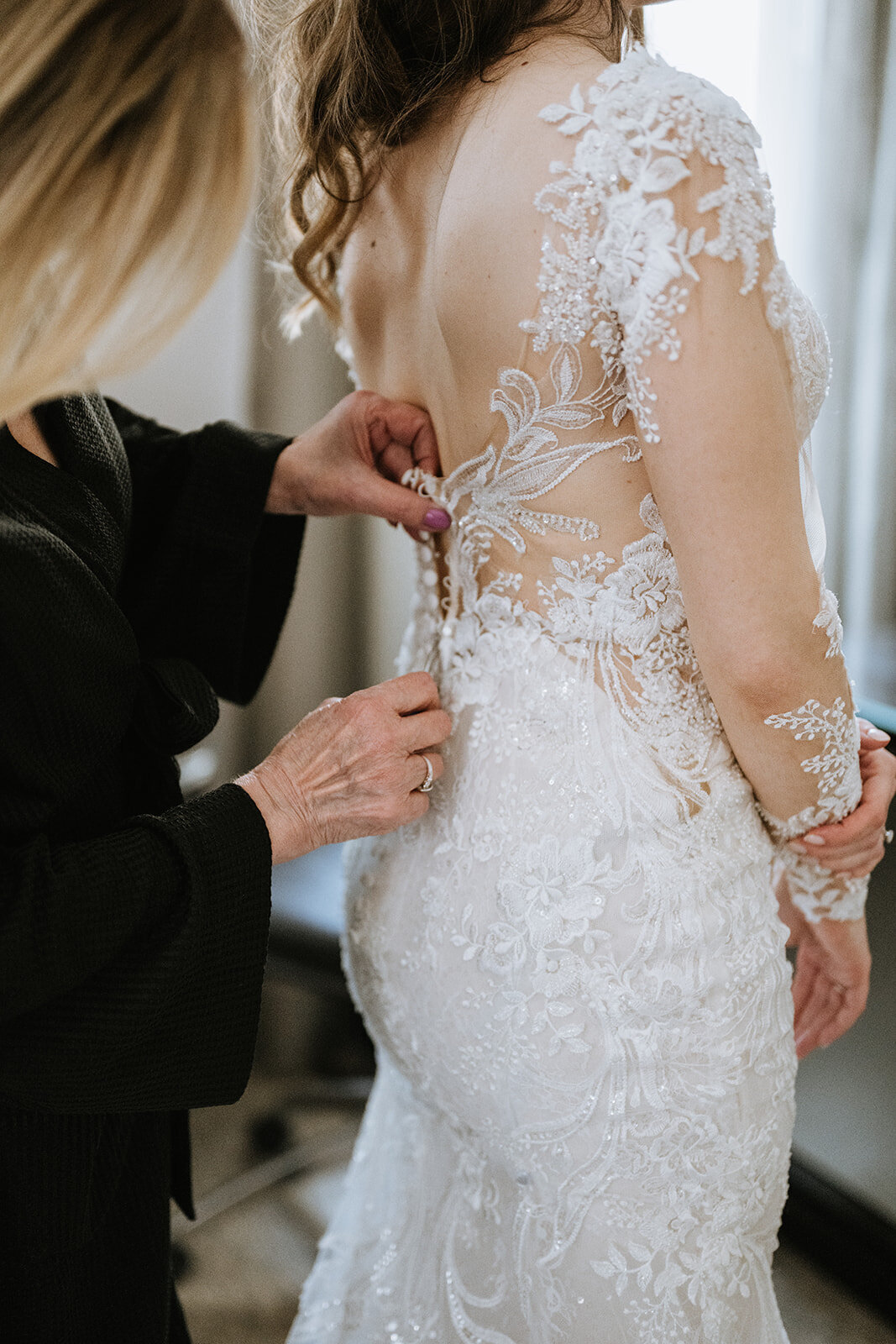 Bride Putting on Wedding Dress