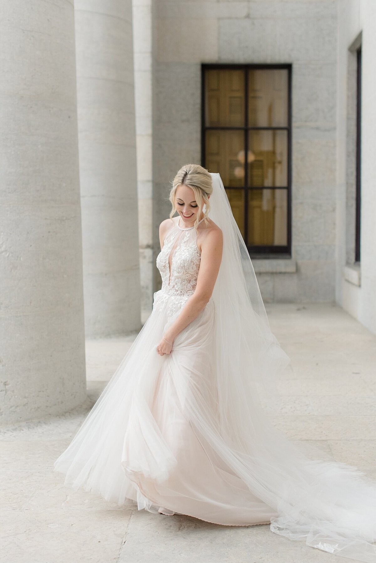 Bride twirling by columns at Ohio State House taken by the best Ohio Wedding Photographer