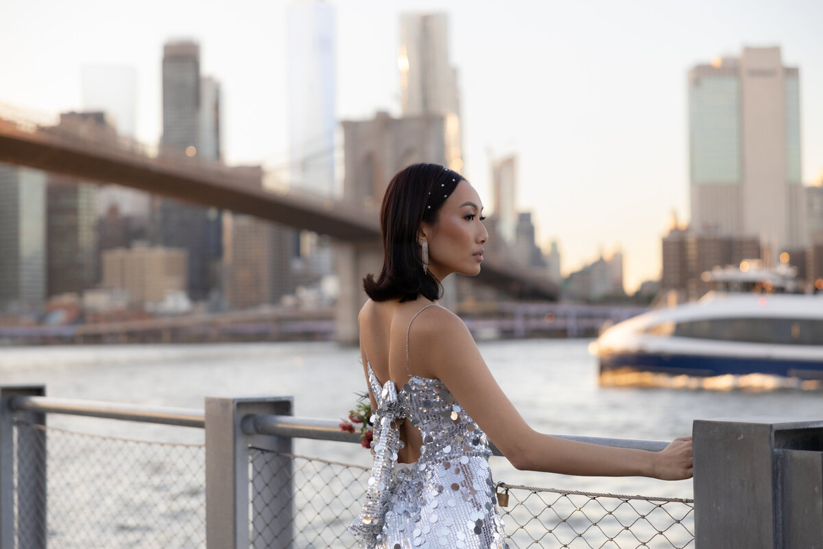 A close-up shot of the bride’s shimmering sequin dress as it catches the light under the bridge.