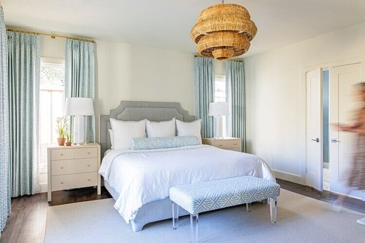 oyster creek studios highland park home white and gray bed with wicker accent lighting in bedroom