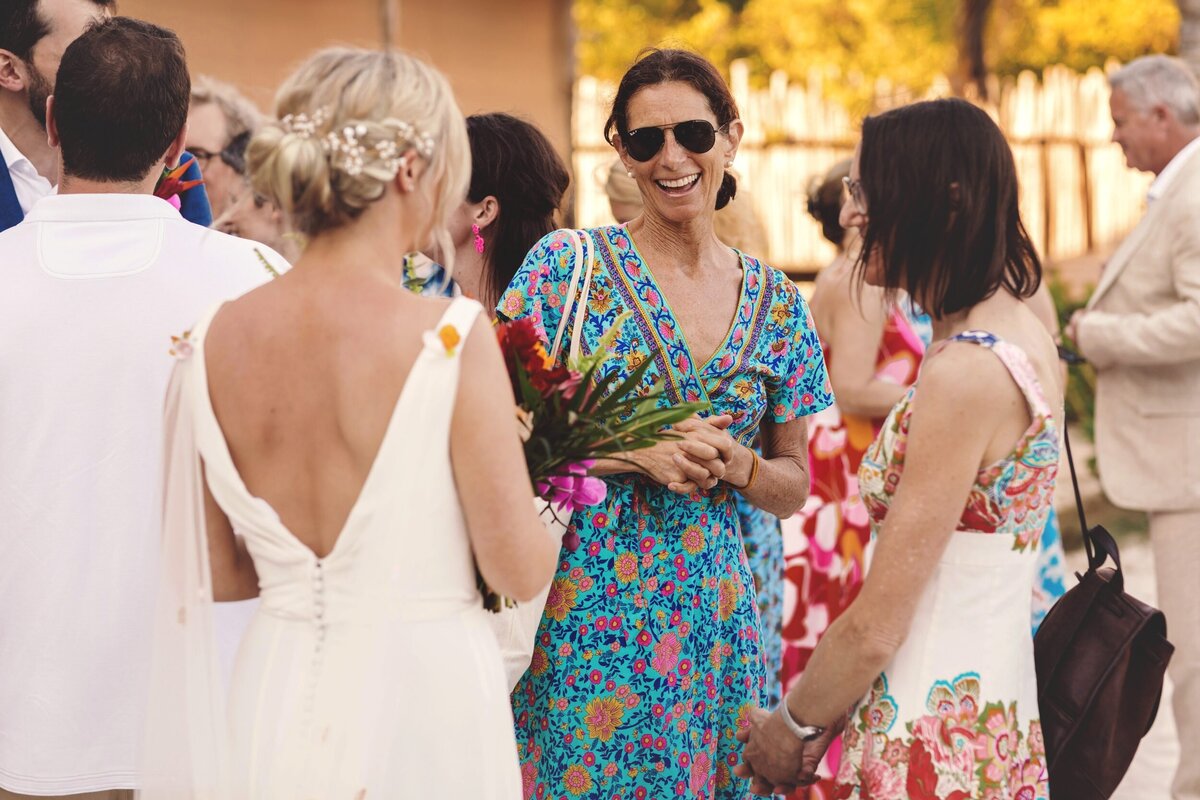 Guests laughing with bride at Blue Venado Seaside Riviera Maya wedding