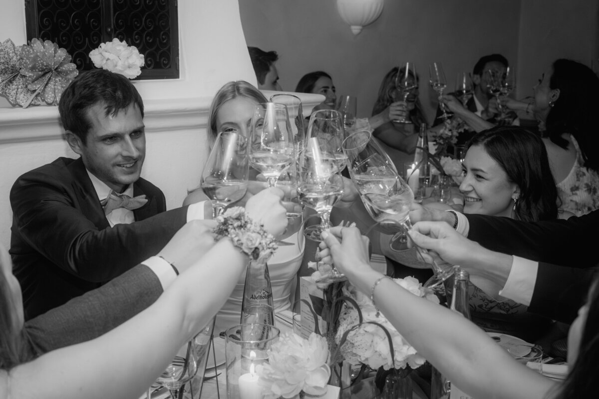 The newly weds raise their glasses with their guests during the wedding celebration.