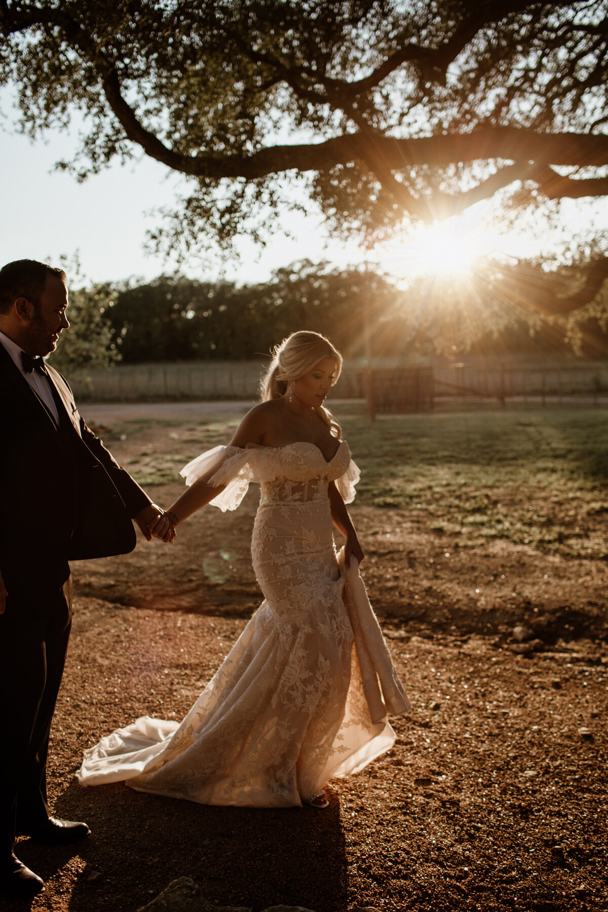 Bride and groom taking a sunset walk at Lazy S Hacienda in Weatherford Texas. Captured by Fort Worth Wedding Photographer, Megan Christine Studio