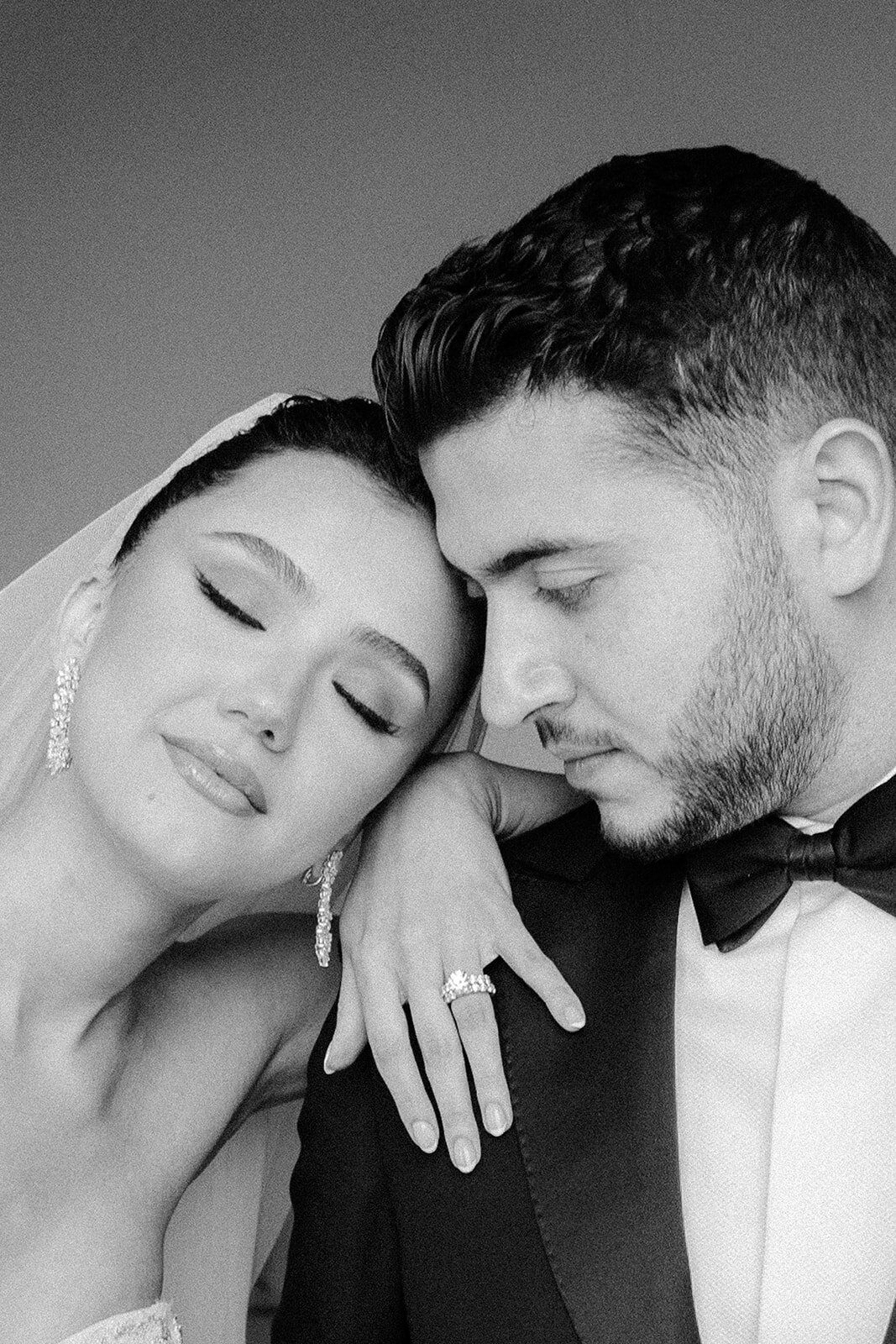 Bride resting on her husband's shoulder