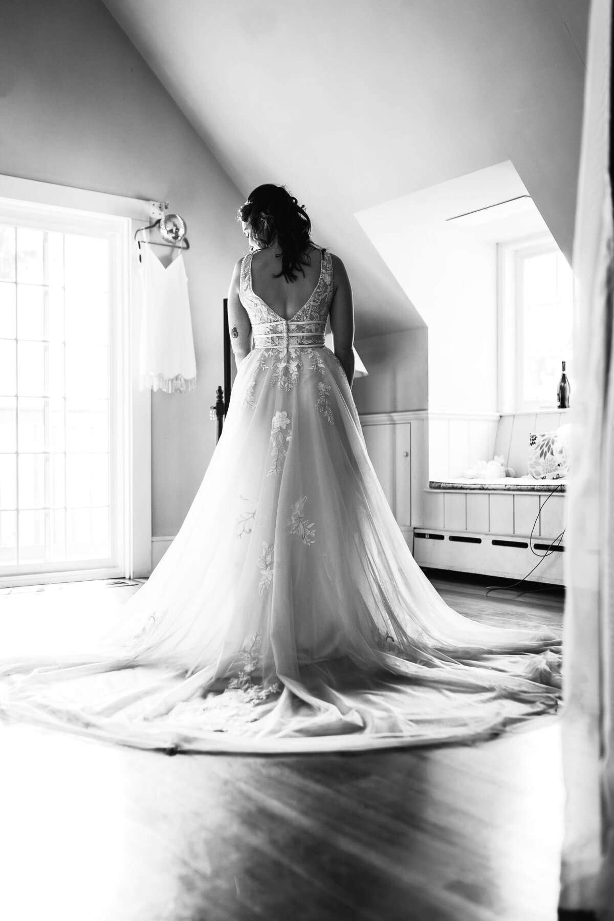 Black and white image of bride in wedding gown in getting ready room at Cobb Hill Estate by Lisa Smith Photography