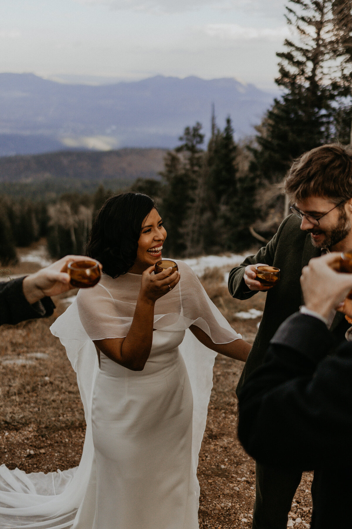 bride adn groom toasting with friends after elopement ceremony