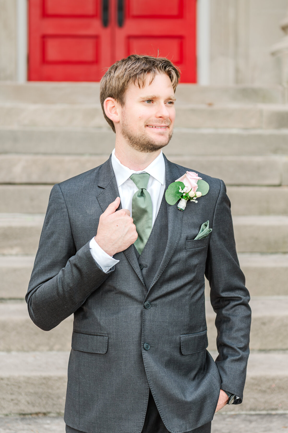 groom posing outside of Carnegie Hall in Lexington