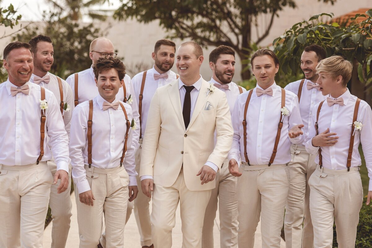 Groomsmen walking together at wedding in Riviera Maya