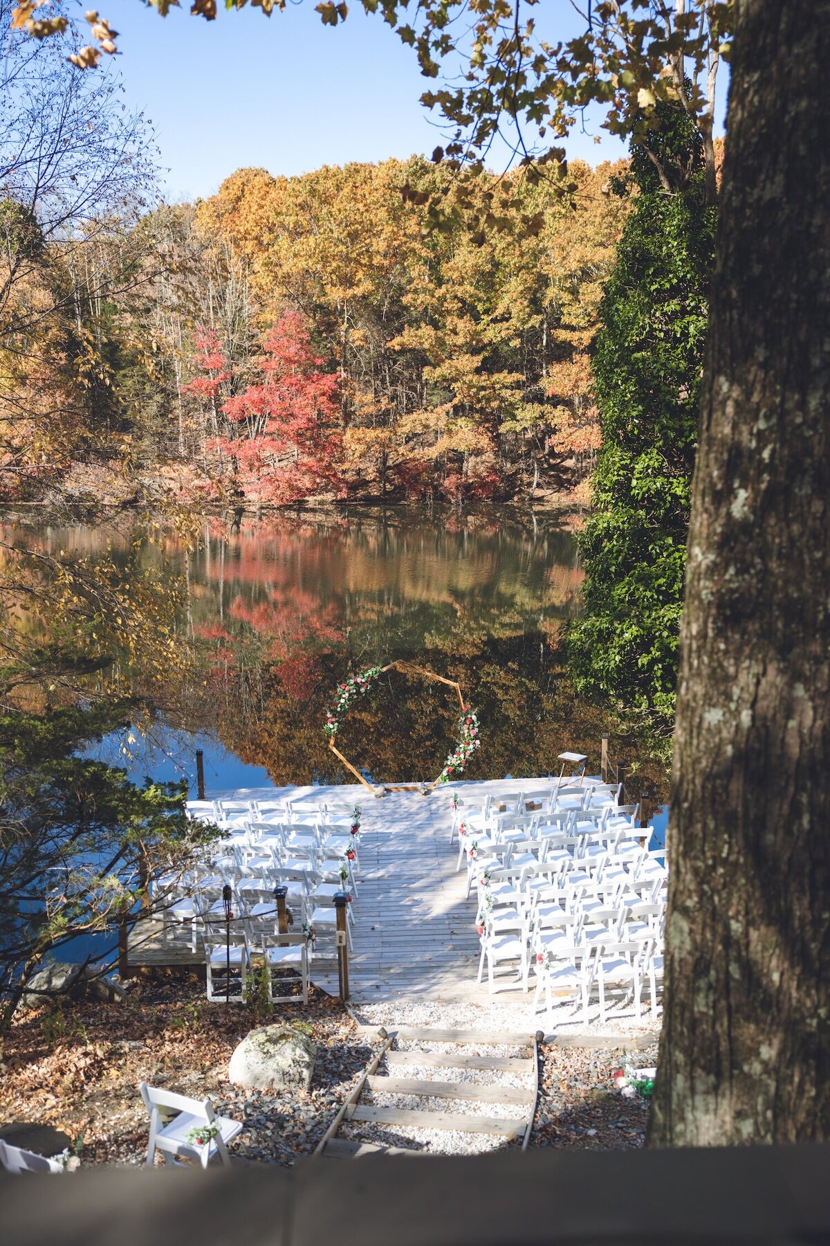 Wide shot of wedding ceremony under golden fall trees at Silver Lake