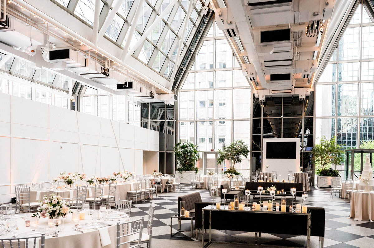 wedding planning design at wintergarden ppg place by hello productions with lots of flowers glass walls and modern furniture
