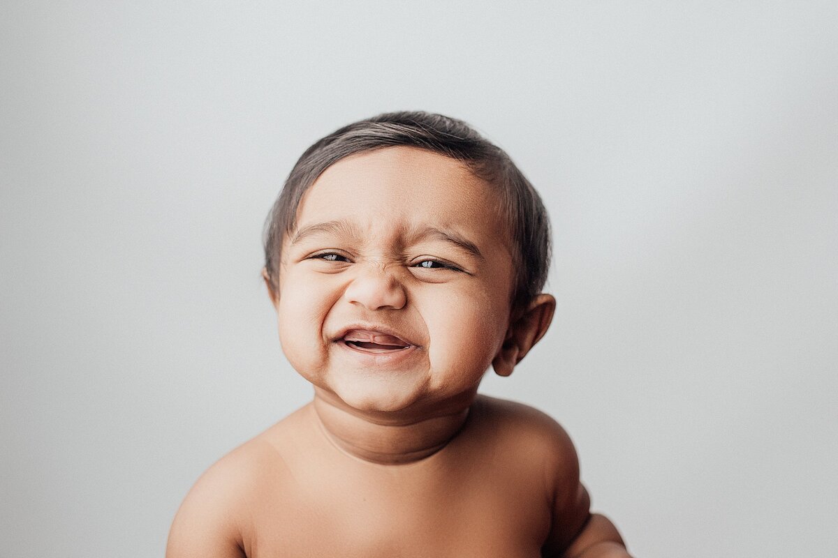 Happy baby laughing during studio milestone session