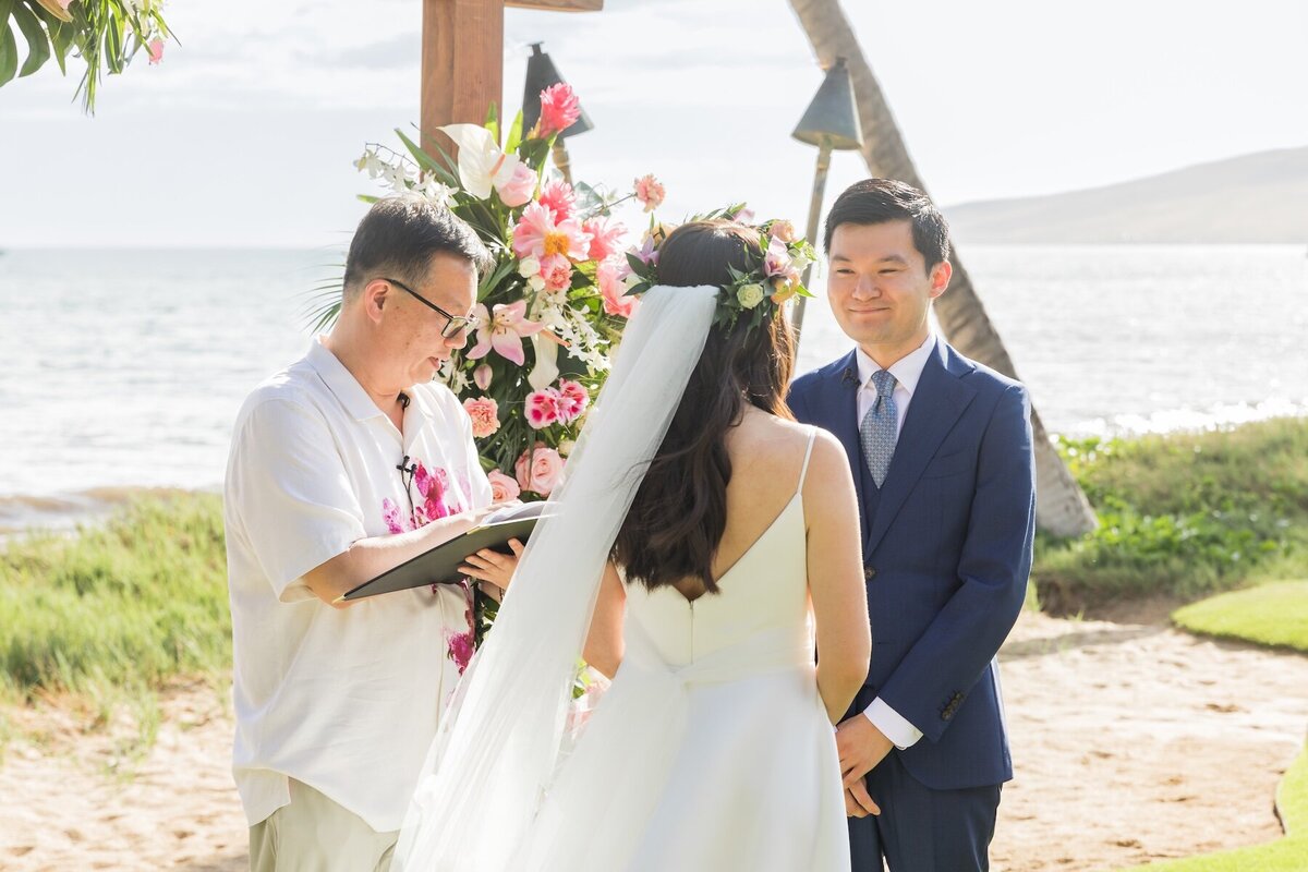 Maui Wedding of bride and groom with officiant during ceremony