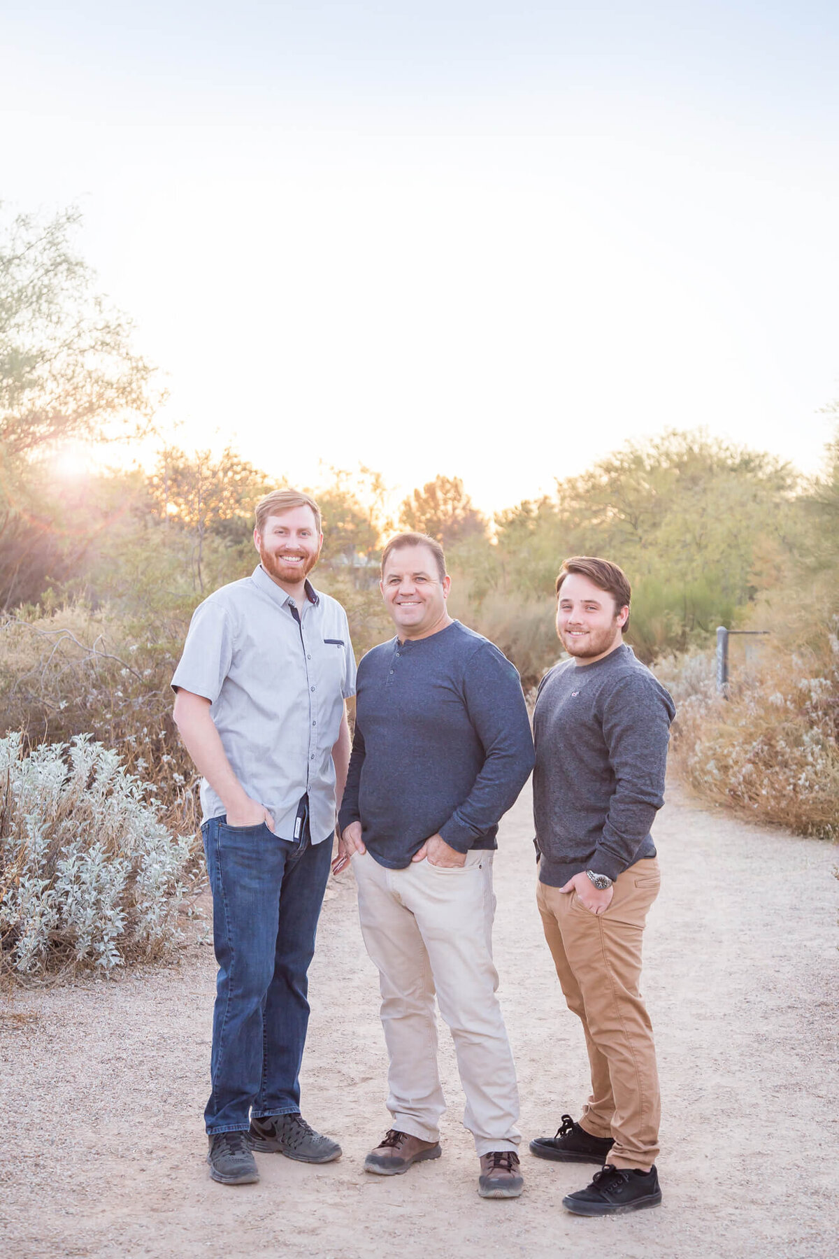 Redheaded man with two  brown haired men standing on a desert path in Riparian Preserve