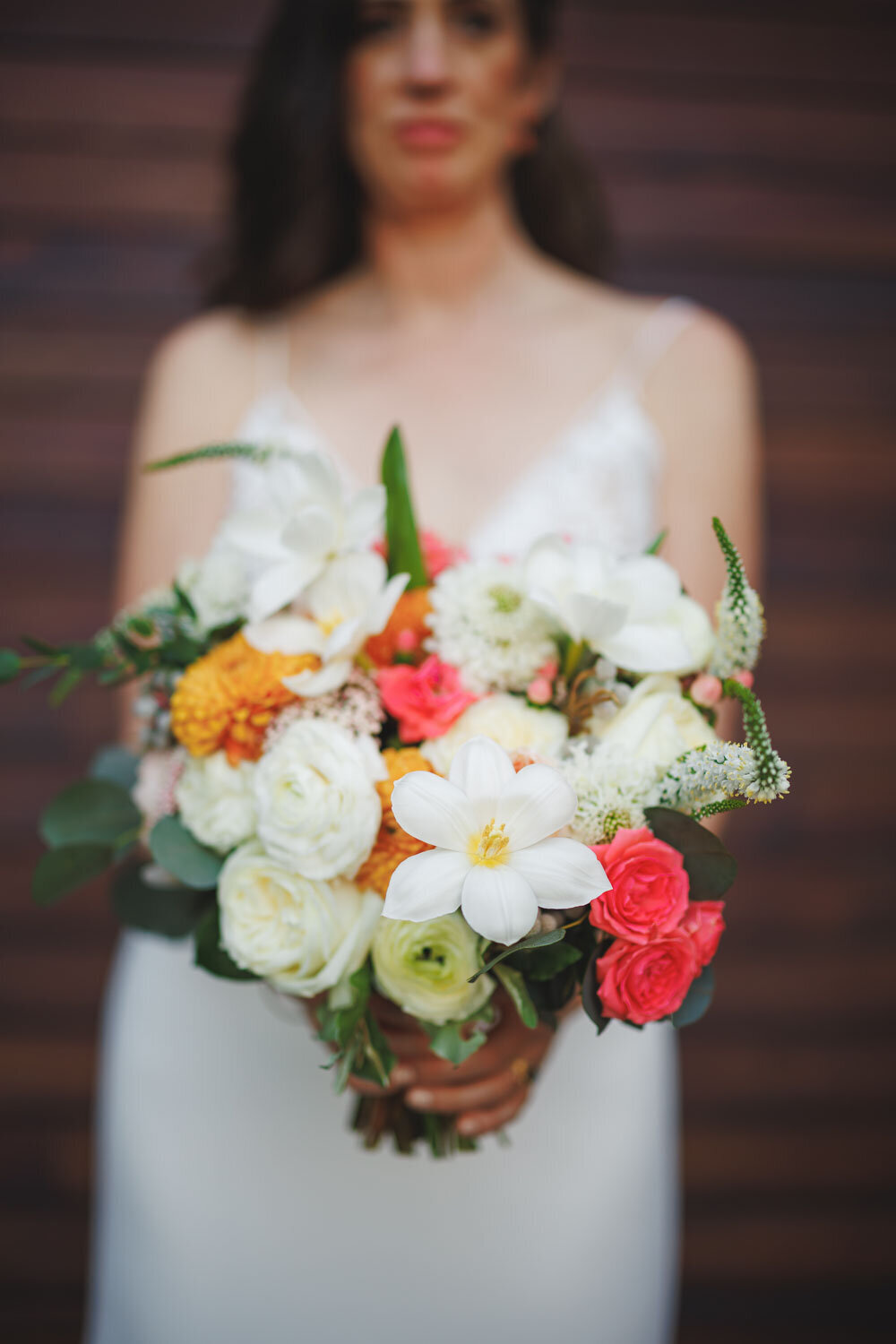 Bride holding her bouquet in front of the camera