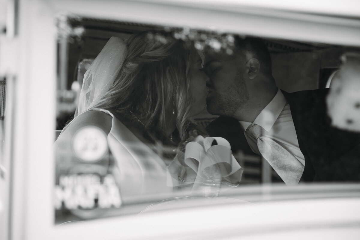 Bride and Groom through car glass