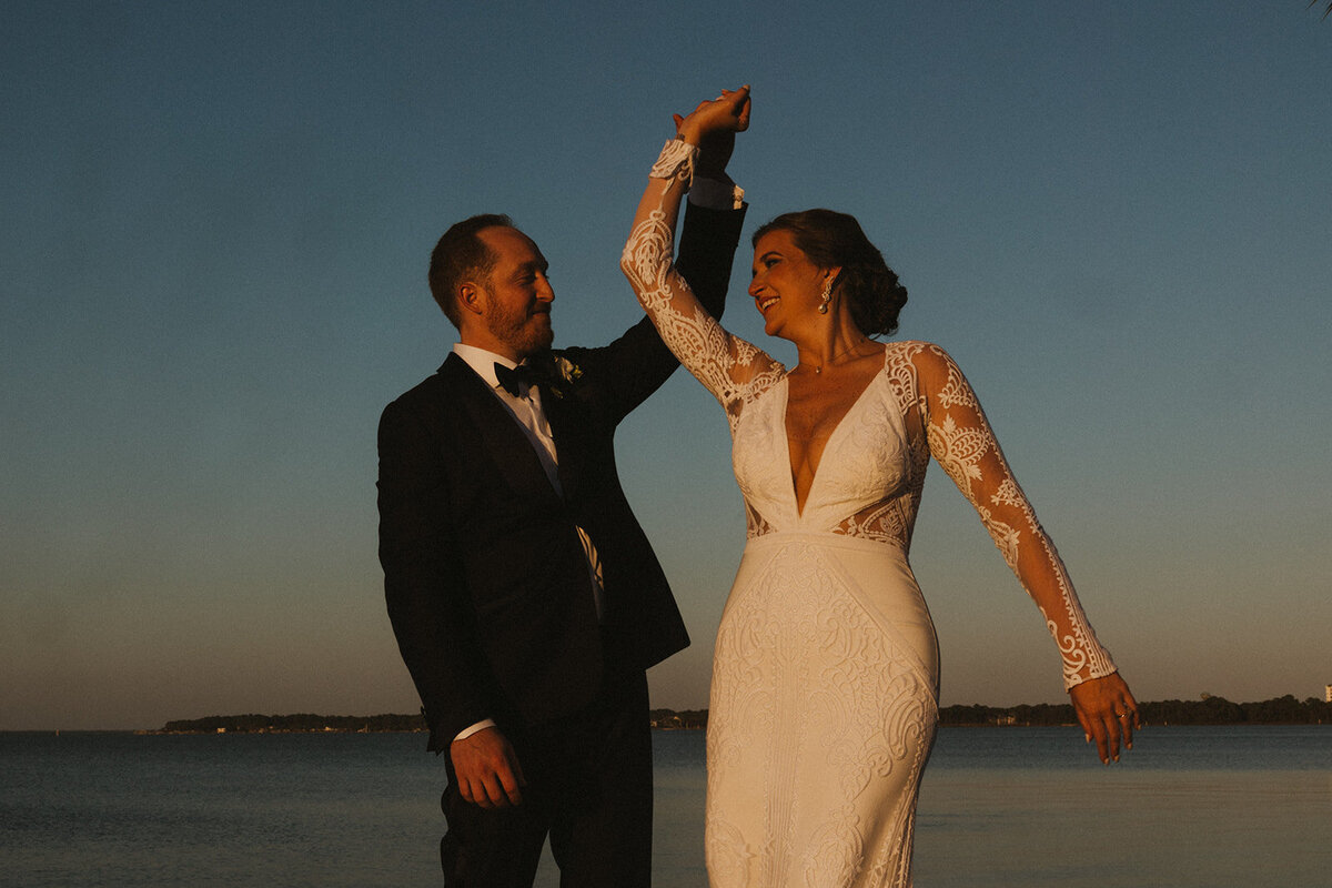 couple dancing by the ocean on their wedding day