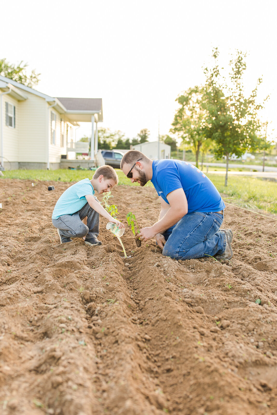 my husband and son planting garden together