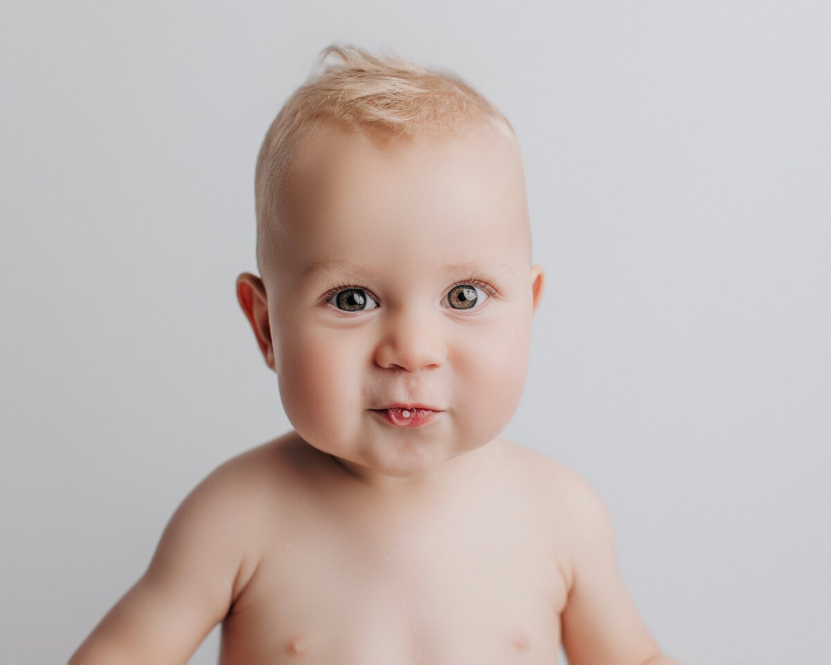 Baby showing off silly faces and giggles during one-year milestone session