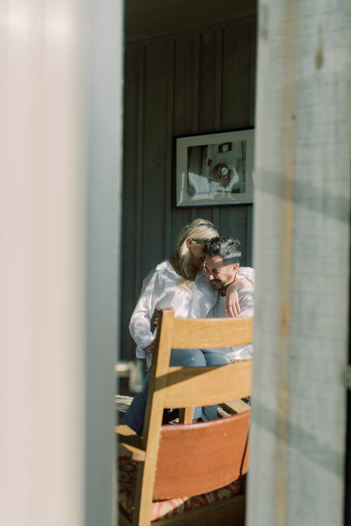 A quiet, whispered moment through the window screen of Elora ON, where love is shared in the soft morning light