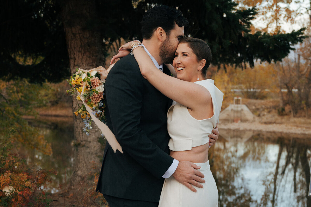 A couple embrace and the woman holds a bouquet at their vow renewal, representing the Boise event planning services of Perfect Thirds & Co. 