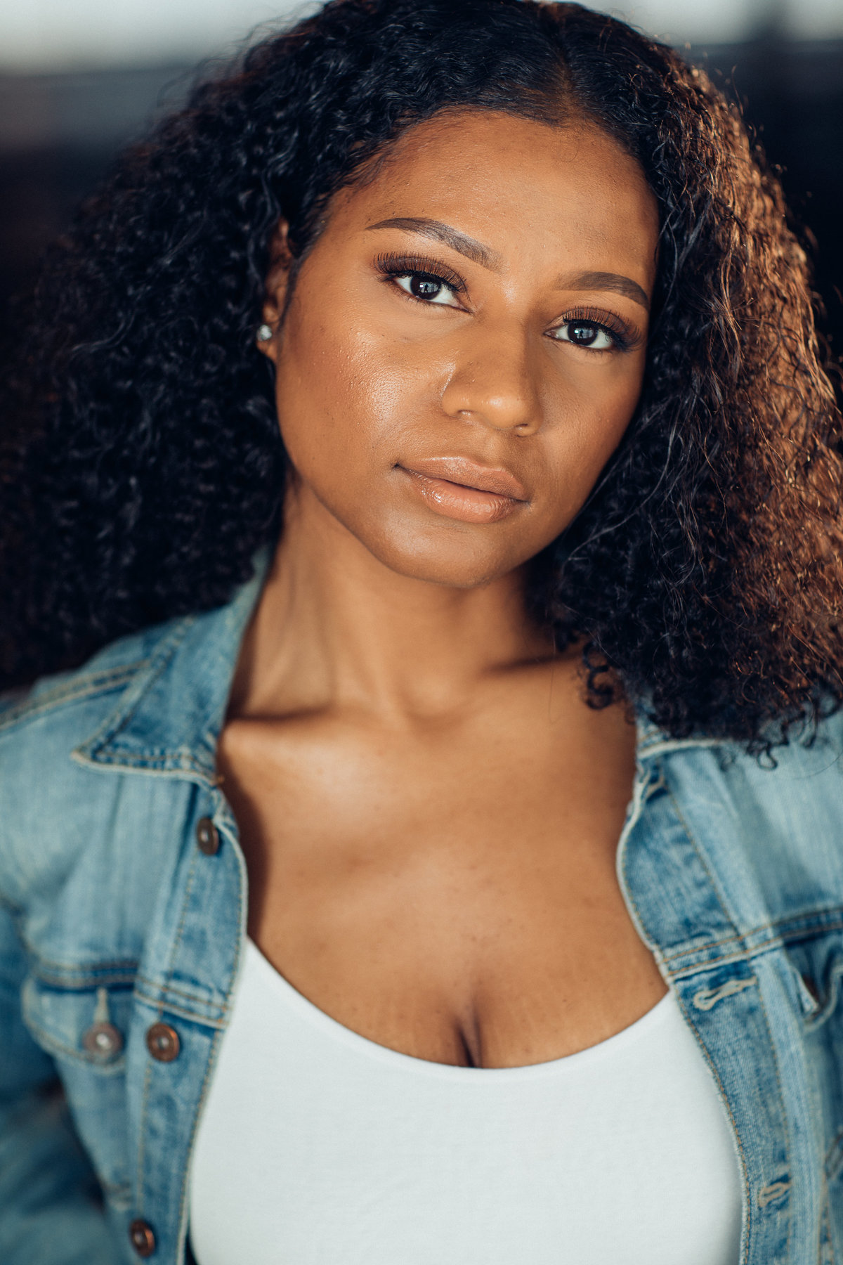 Headshot Photograph Of Young Woman In Faded Blue Denim Jacket And Inner White Tank Top Los Angeles