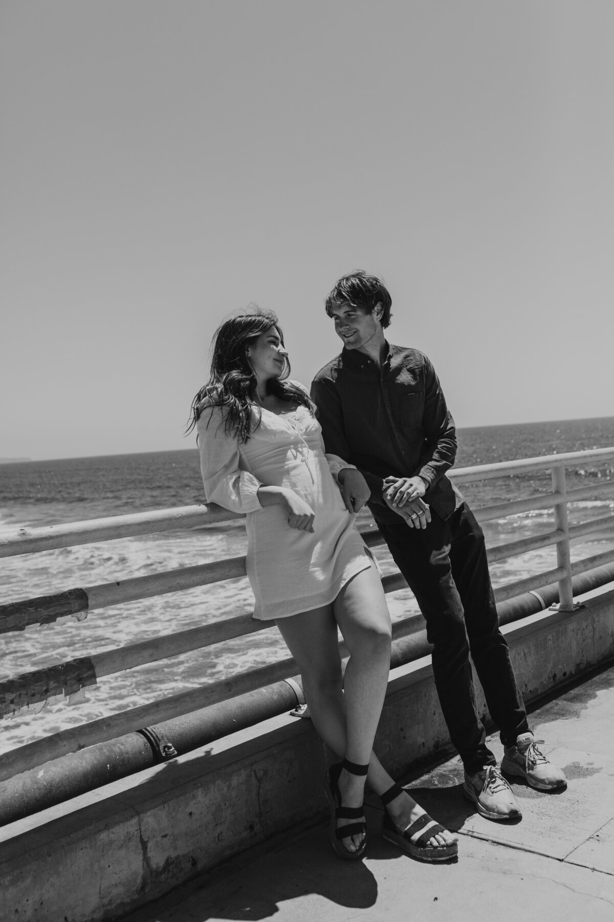 Couple walking along the ocean shore, intimate Indiana engagement session.