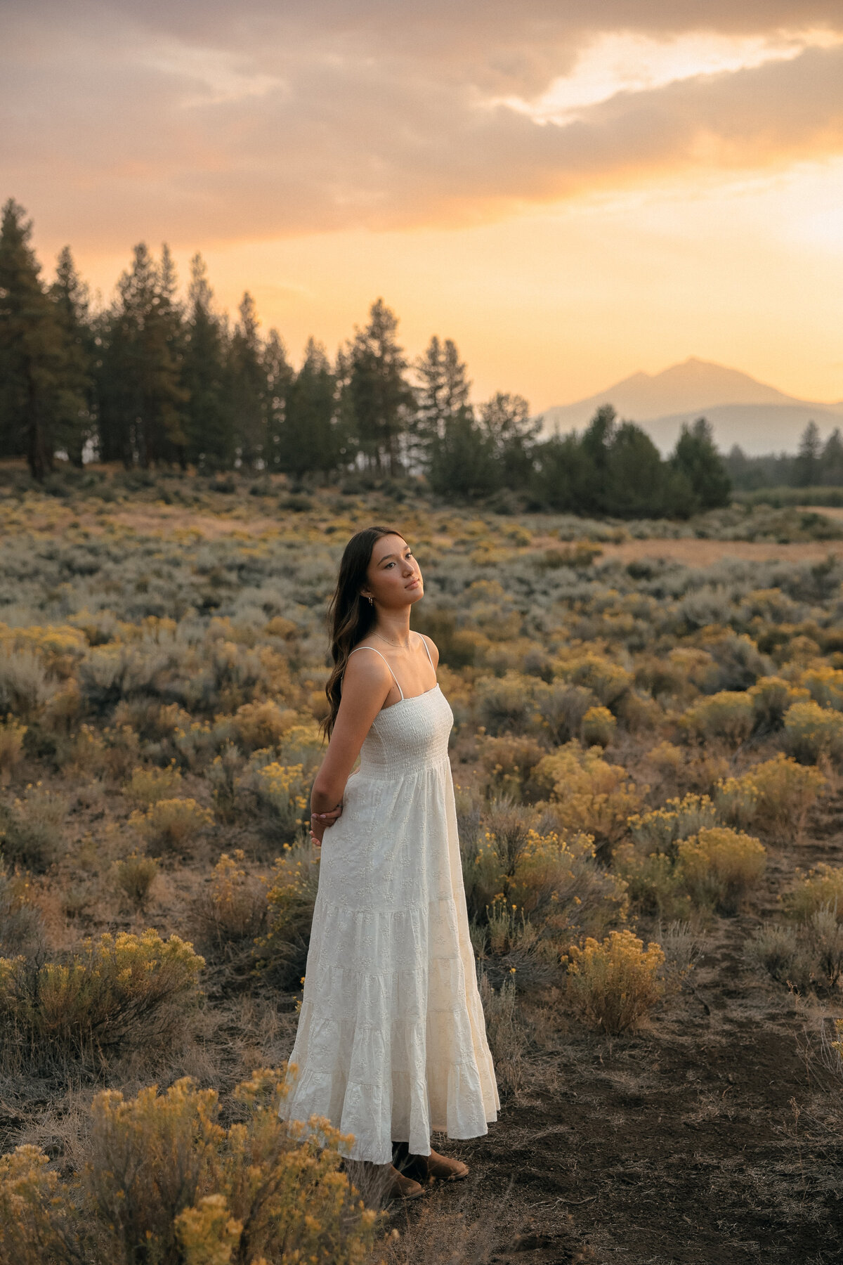 Black and White Graduation Photo of Girl Holding Cap Beside Horse on Family Farm