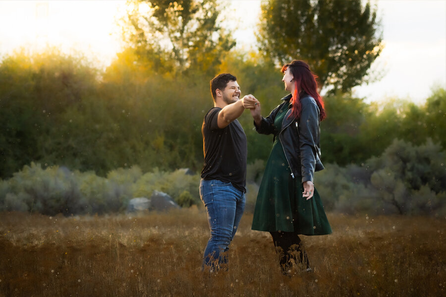 Couple dancing in a fall field.