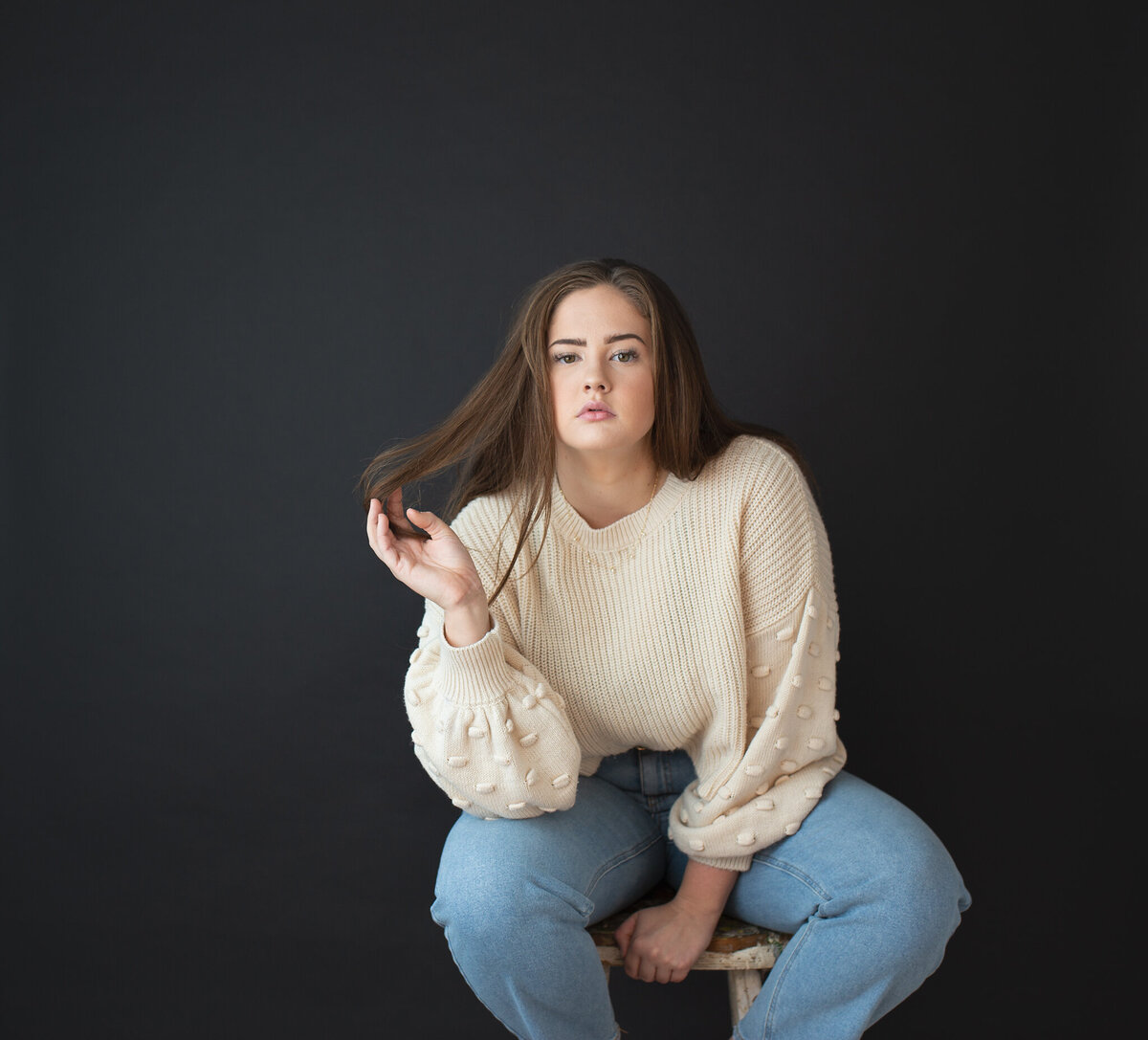 in studio senior pictures girl sitting on stool